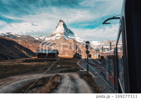 Matterhorn mountain with train running through on sunny day at Riffelboden, Zermatt, Switzerland 109277311