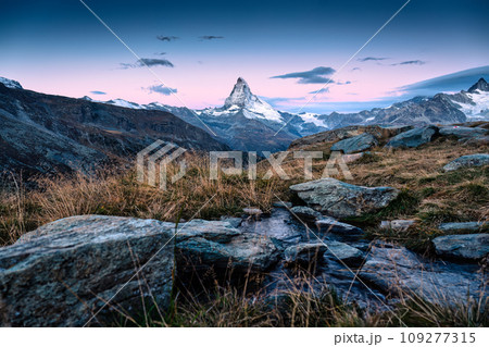 Sunrise over Matterhorn mountain on meadow and stream flowing at Zermatt, Switzerland 109277315