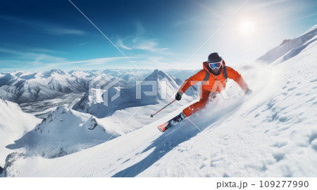 A skier descends at high speed on a snow-covered ski slope at a resort in an orange suit. A skier descends at high speed on a snow-covered ski slope at a resort in an orange suit. 109277990