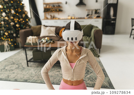 A young, beautiful woman shares her thoughts and feelings while wearing a virtual reality headset. 109278634