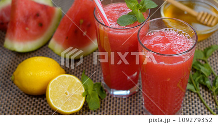 Watermelon banana orange Smoothie is poured into a glass on the background of fresh fruits 109279352