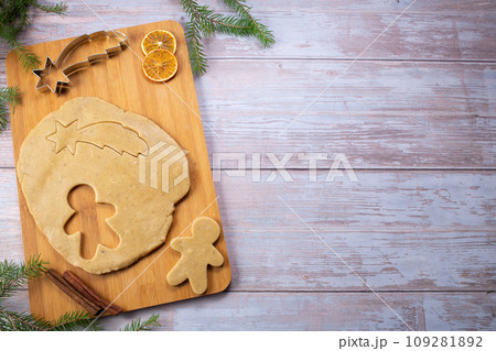 Christmas baking. Ginger dough for gingerbread, gingerbread men, star, Christmas trees, spices. Flat lay.Copy space Christmas baking. Ginger dough for gingerbread, gingerbread men, star, Christmas trees, spices. Flat lay.Copy space 109281892