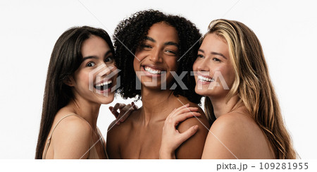 Female models of different ages celebrating their natural bodies in a studio. Three confident and happy women smiling cheerfully. Women standing together against a studio background. Female models of different ages celebrating their natural bodies in a studio. Three confident and happy women smiling cheerfully. Women standing together against a studio background. 109281955