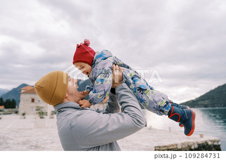 Laughing dad throws up a little girl on the island of Gospa od Skrpjela. Montenegro 109284731