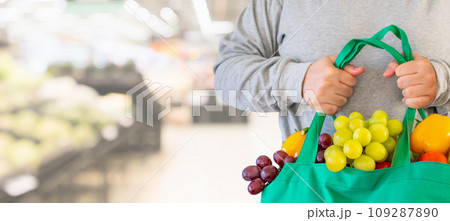 Woman hold grocery shopping bag in supermarket 109287890