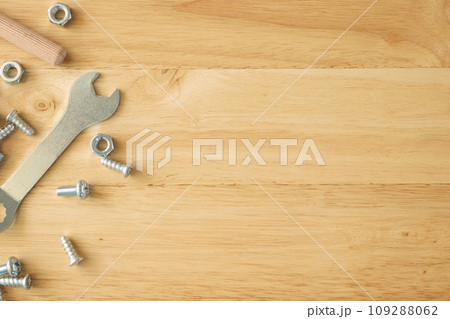 Assembly furniture tool kit with screw dowel wrench and bolt on wood table 109288062