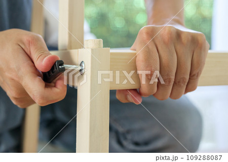 Assembly wooden furniture at home using screw allen 109288087