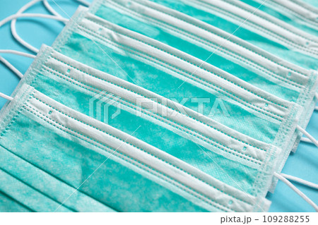 Surgical face mask on blue background protection against COVID-19 coronavirus. Healthcare and medical concept 109288255