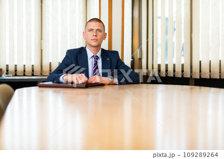Man with briefcase waiting for job interview at office 109289264
