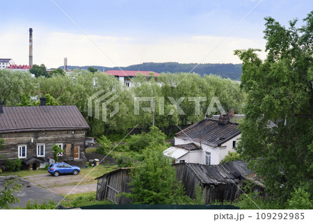 Backyard of a street with wooden houses, sheds and trees in the town of Sortavala in Karelia Backyard of a street with wooden houses, sheds and trees in the town of Sortavala in Karelia 109292985