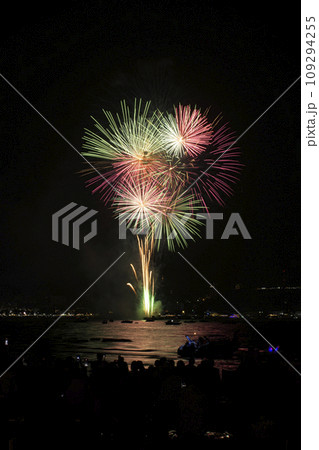 Colorful fireworks celebration with people and the city night light background at the seaside. 109294255