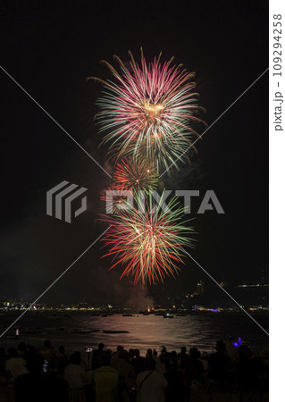 Colorful fireworks celebration with people and the city night light background at the seaside. Colorful fireworks celebration with people and the city night light background at the seaside. 109294258