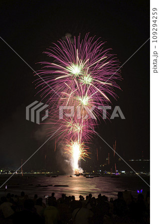 Colorful fireworks celebration with people and the city night light background at the seaside. Colorful fireworks celebration with people and the city night light background at the seaside. 109294259