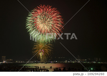 Colorful fireworks celebration with people and the city night light background at the seaside. 109294260
