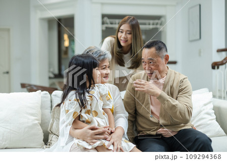 Happy Family Grandfather Grandmother and Granddaughter having fun living room at home.  109294368