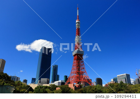 Tokyo Tower with the new Toranomon Hills building in the background on a sunny day against a blue sky as seen from Shiba Park in Tokyo, Japan Tokyo Tower with the new Toranomon Hills building in the background on a sunny day against a blue sky as seen from Shiba Park in Tokyo, Japan 109294411