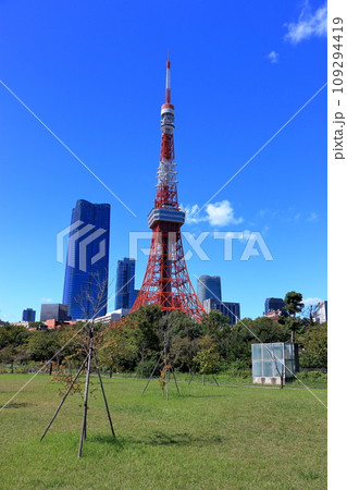 Tokyo Tower with the new Toranomon Hills building in the background on a sunny day against a blue sky as seen from Shiba Park in Tokyo, Japan Tokyo Tower with the new Toranomon Hills building in the background on a sunny day against a blue sky as seen from Shiba Park in Tokyo, Japan 109294419