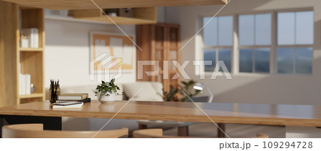 Copy space on a wooden tabletop with a potted plant and stationery on the table in a living room. 109294728