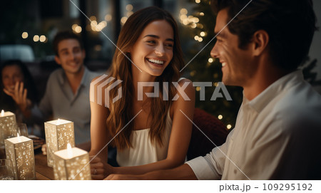 A happy girl and man, are sitting at a New Year's table in a restaurant A happy girl and man, are sitting at a New Year's table in a restaurant 109295192