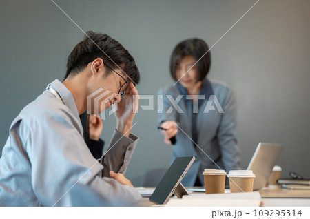An upset young Asian businessman is being complained about by his senior boss during the meeting. An upset young Asian businessman is being complained about by his senior boss during the meeting. 109295314