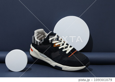 Stylish sneakers with a white sole on a blue background Stylish sneakers with a white sole on a blue background 109301079