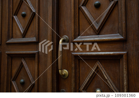 Close-up view of an old massive wooden door 109301360
