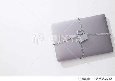 The laptop is wrapped in a chain with a lock 109303542