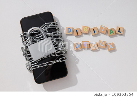 The smartphone is encased in a chain with a lock 109303554