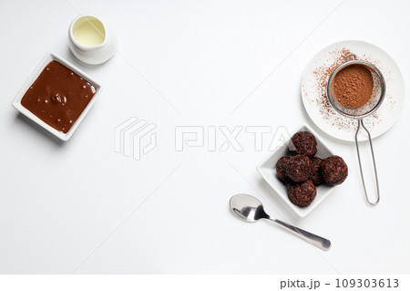 Brigadeiro, bowl with chocolate and cocoa powder on white background, space for text 109303613