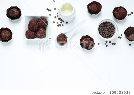Brigadeiro and chocolate chips in bowls on white background, space for text 109303632