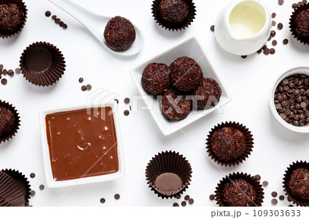 Brigadeiro and chocolate in bowls on white background, top view 109303633