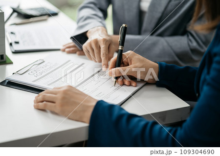 House model with agent asking costumer for contract to buy, get insurance or loan real estate or property. House model with agent asking costumer for contract to buy, get insurance or loan real estate or property. 109304690