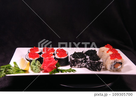 Three types of sushi rolls with white and black sesame seeds with black paddlefish caviar, red chum salmon caviar and pink salmon on one plate. Delicious food, beautiful presentation. Three types of sushi rolls with white and black sesame seeds with black paddlefish caviar, red chum salmon caviar and pink salmon on one plate. Delicious food, beautiful presentation. 109305700
