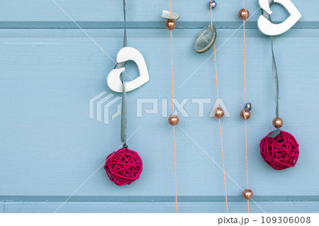 Handmade Christmas decoration hangs on a blue wall Handmade Christmas decoration hangs on a blue wall 109306008