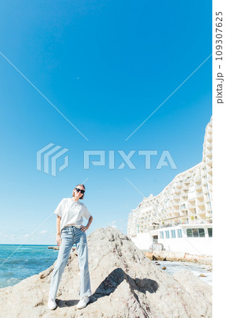 Beautiful slender woman walking on the beach near the seashore 109307625