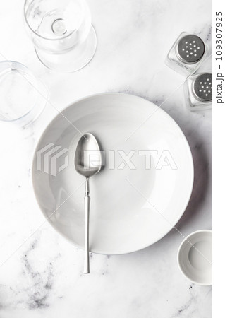 Set of soup plates and dinnerware on white marble background Set of soup plates and dinnerware on white marble background 109307925