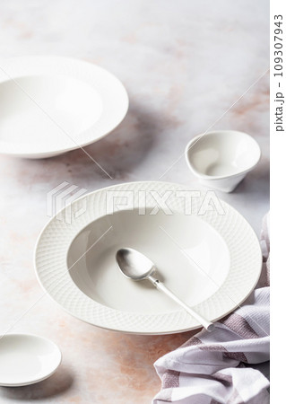 Set of soup plates and dinnerware on white marble background Set of soup plates and dinnerware on white marble background 109307943