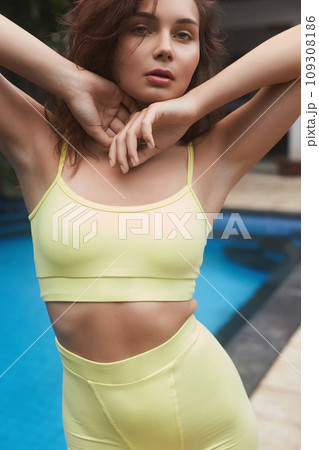 beautiful girl in yellow.young brunette woman near swimming pool beautiful girl in yellow.young brunette woman near swimming pool 109308186