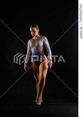 Gymnastics, woman acrobat, female gymnast strong flexible body over black and white background 109308785