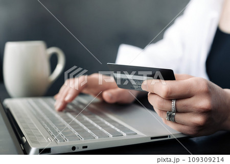Effortless E-commerce: Woman's Hand Balancing Credit Card and Laptop. Seamless Online Shopping Effortless E-commerce: Woman's Hand Balancing Credit Card and Laptop. Seamless Online Shopping 109309214