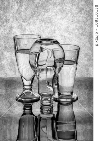 Still life with glass objects on a gray background 109310138