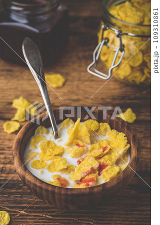 Breakfast with corn flakes, milk and berry syrup Breakfast with corn flakes, milk and berry syrup 109310861