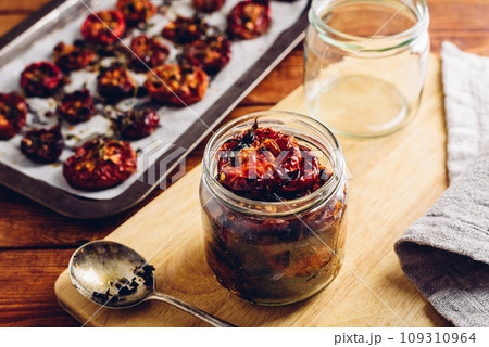 Freshly Cooked Sun Dried Tomatoes with Thyme in a Glass Jar Freshly Cooked Sun Dried Tomatoes with Thyme in a Glass Jar 109310964