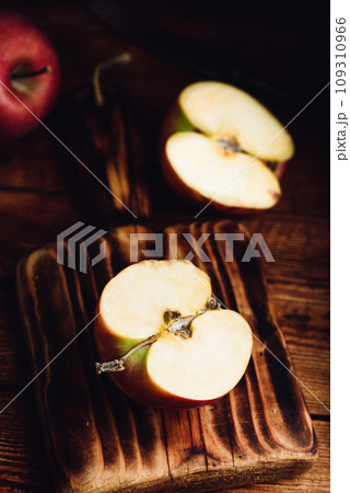 Halved Red Apple on Cutting Board 109310966