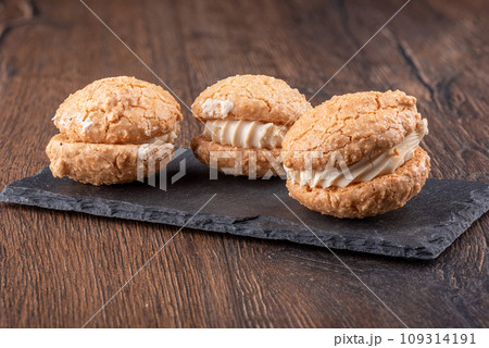 Three delicious coconut cream cookies on a mica serving board. Three delicious coconut cream cookies on a mica serving board. 109314191