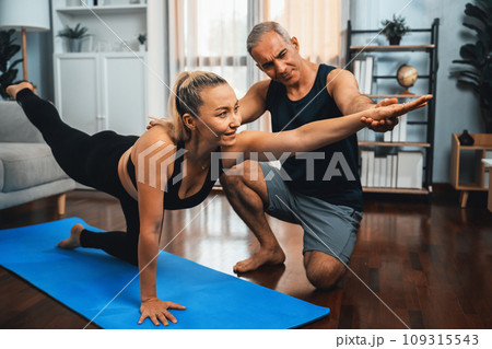 Happy active senior couple in sportswear doing yoga. Clout 109315543