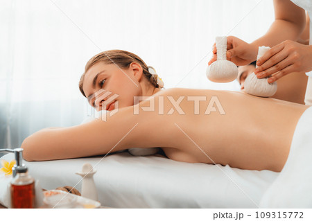 Hot herbal ball spa massage body treatment at day spa . Quiescent Hot herbal ball spa massage body treatment at day spa . Quiescent 109315772