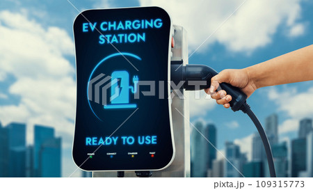 Hand pull and hold EV charger from empty screen charging station. Peruse Hand pull and hold EV charger from empty screen charging station. Peruse 109315773