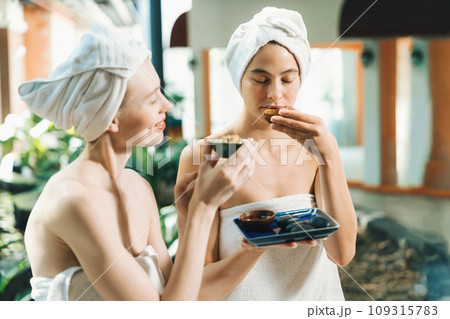 Couple of beautiful girls interested in homemade facial mask.Tranquility. Couple of beautiful girls interested in homemade facial mask.Tranquility. 109315783