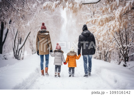 Happy family Father, mother and children are on winter walk in nature comeliness Happy family Father, mother and children are on winter walk in nature comeliness 109316142